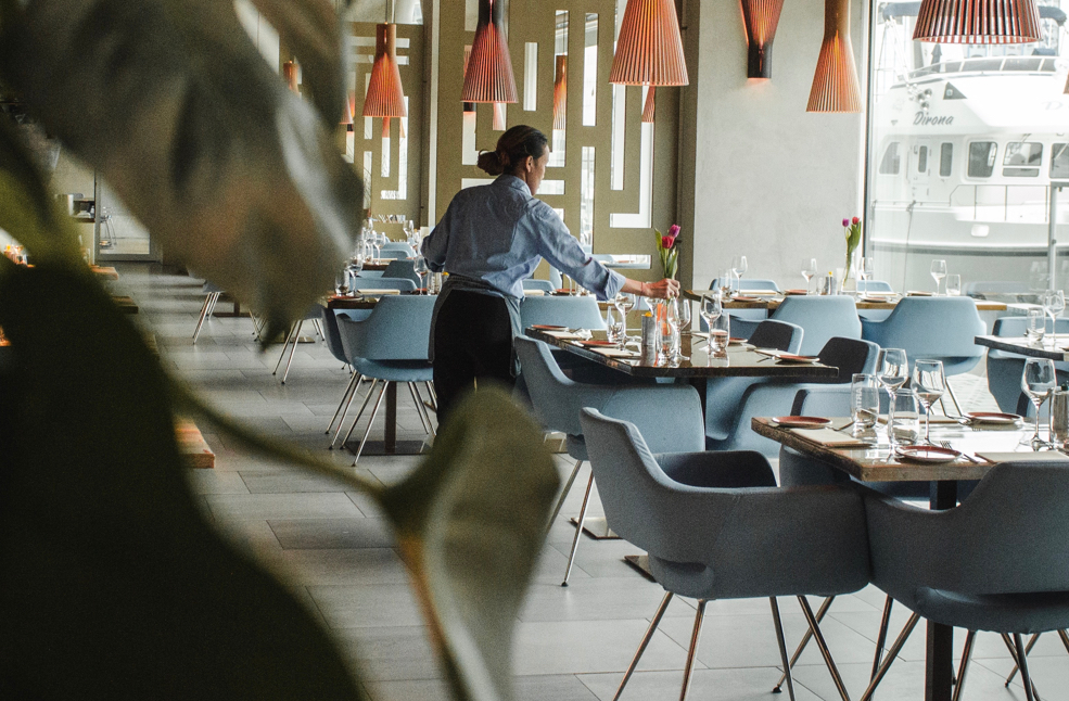 a server setting up tables in a restaurant