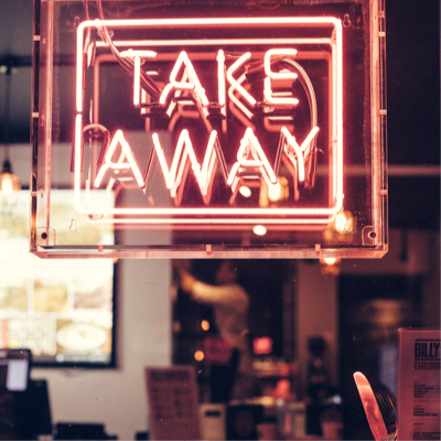 A light up pink sign on a window that says 'Take Away'
